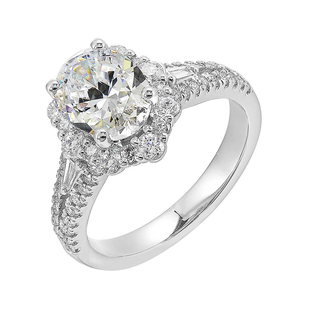 The delicate floral halo around the solitare with baguette diamonds along the sides makes this ring a glamorous choice.