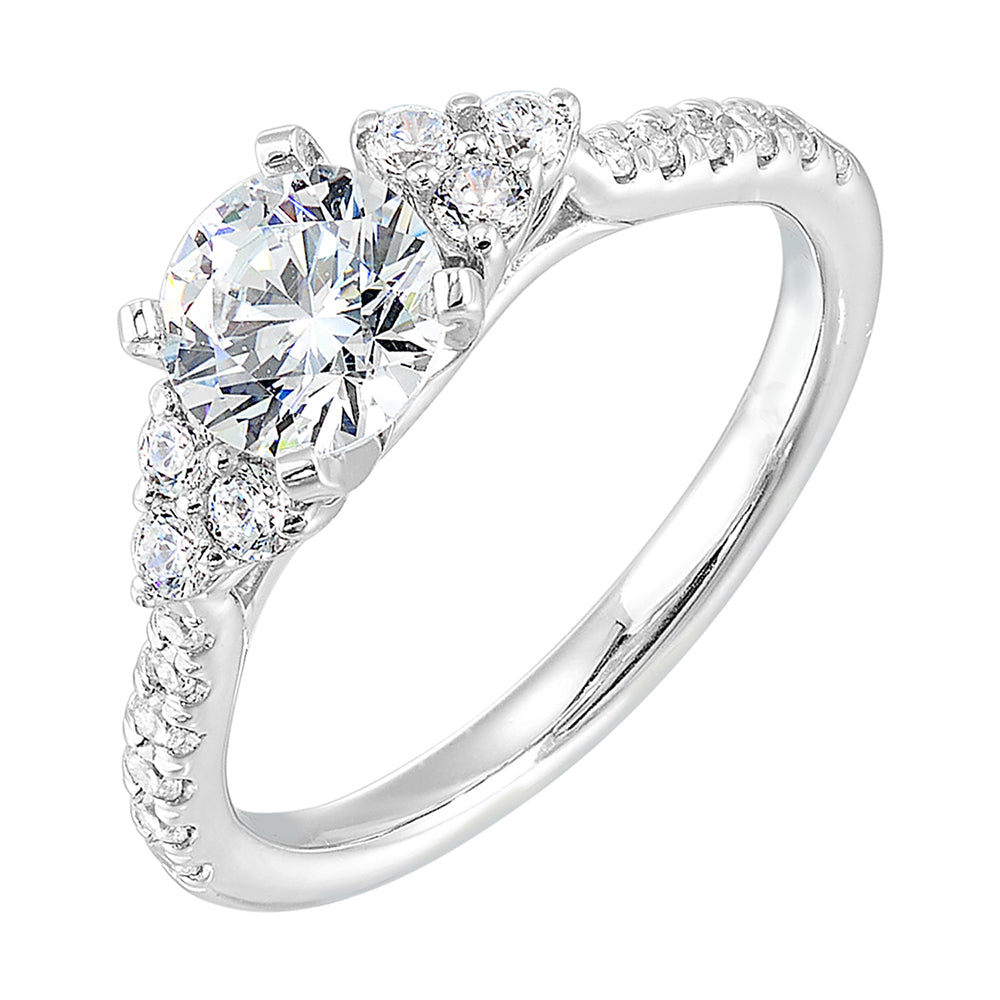 Three stone ring with a cluster of diamonds along the shoulder followed by a tapered diamond shank is sure to complement her.