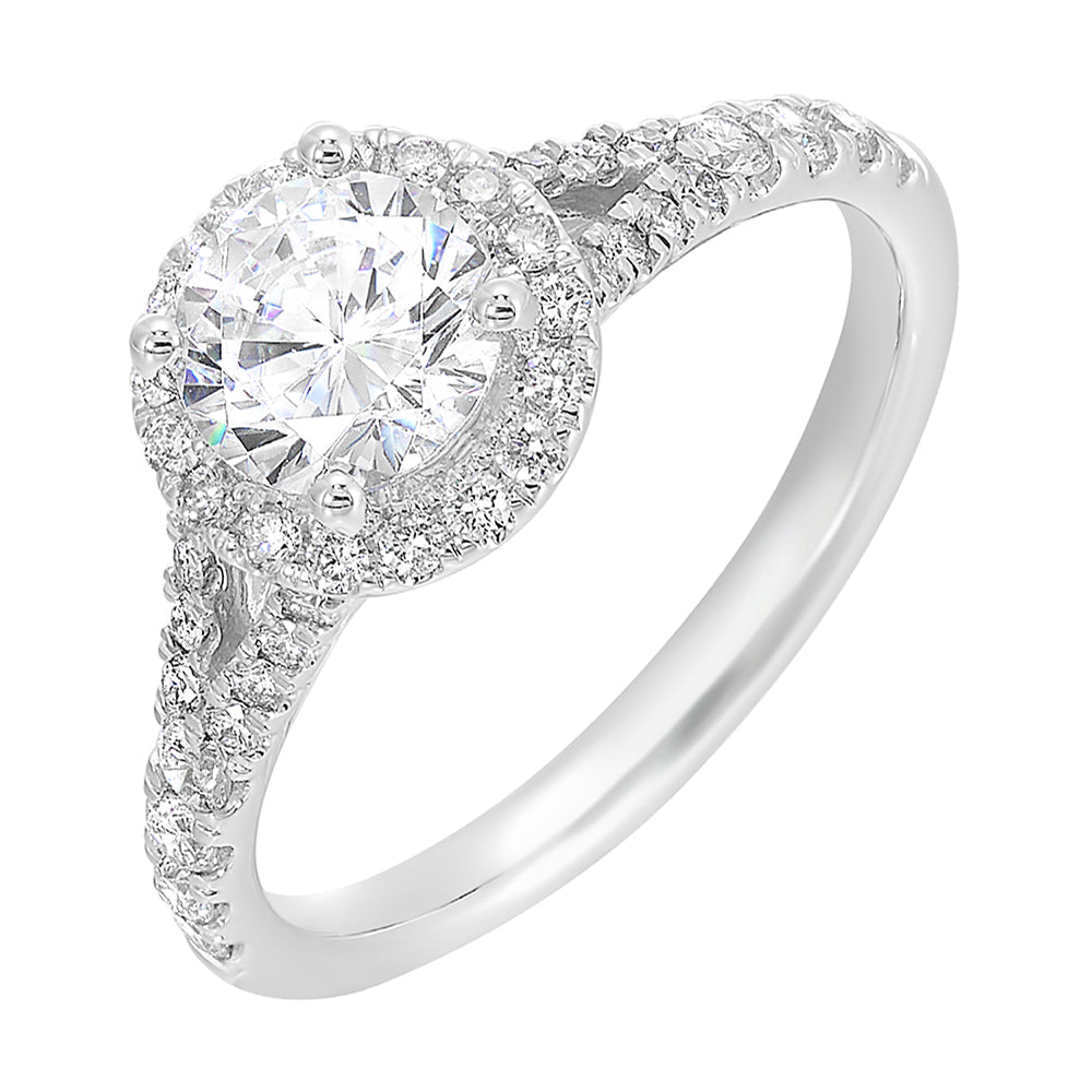 This ring stuns with a round solitaire embraced by a halo and a delicate split shank. Its a unique symbol of your love story.