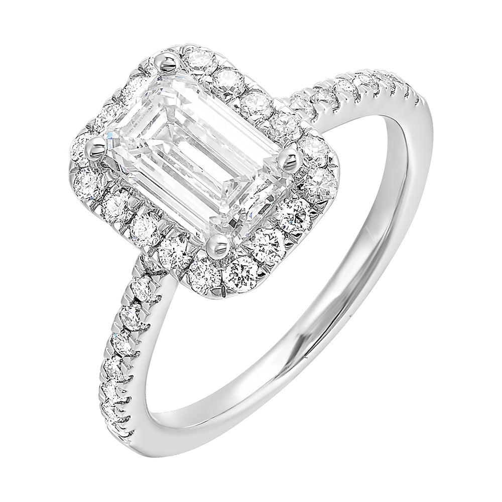 A beautiful emerald cut solitare set with halo of round diamonds and a diamond studded shank makes this perfect choice of your love story.