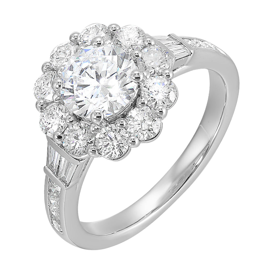 Elegant and romantic, this engagement ring highlights a floral inspired halo followed by a tapered shank of baugette and round diamonds.