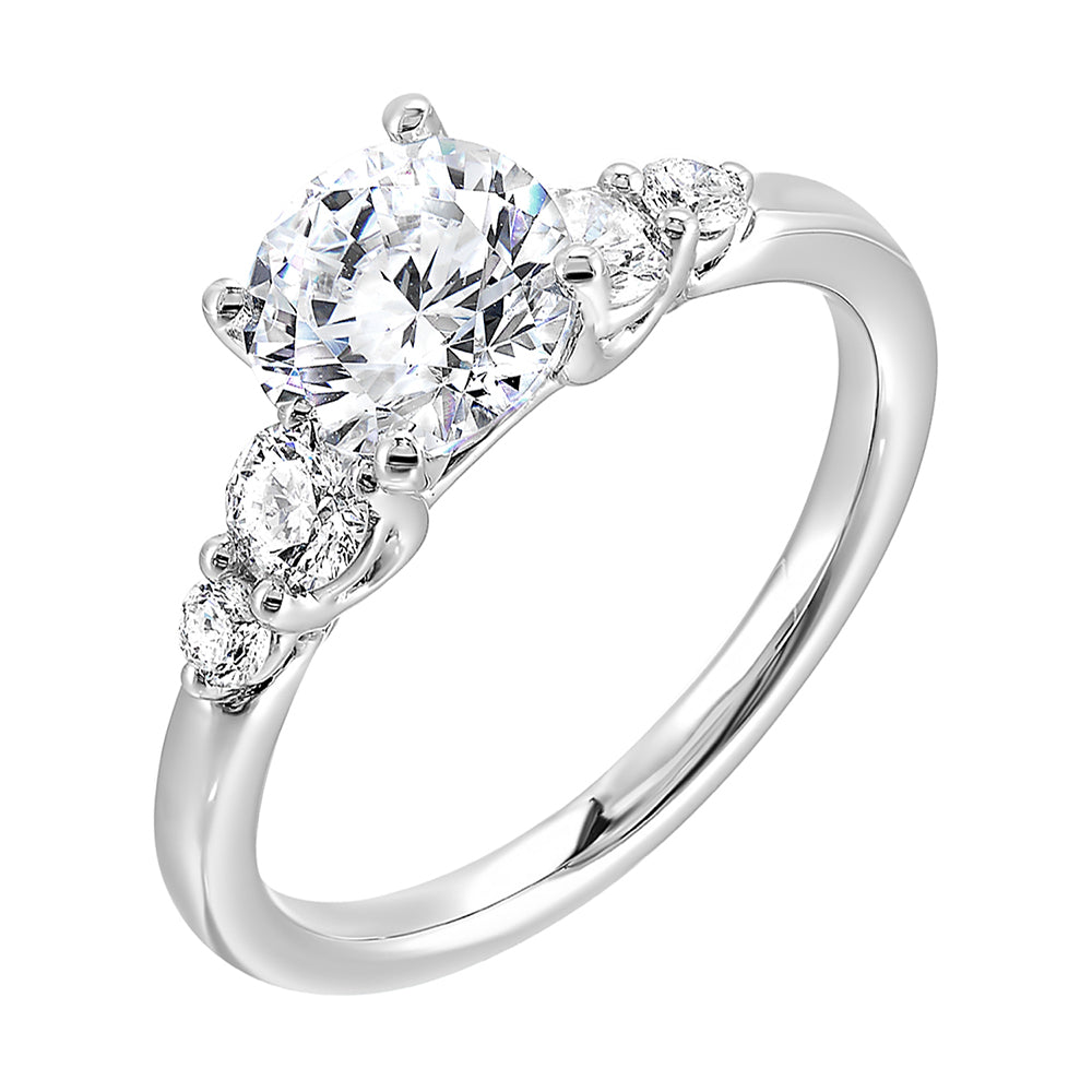 Five times diamonds for five times sparkles. A classic,  lustrous band completes the look of this five stone engagement ring.