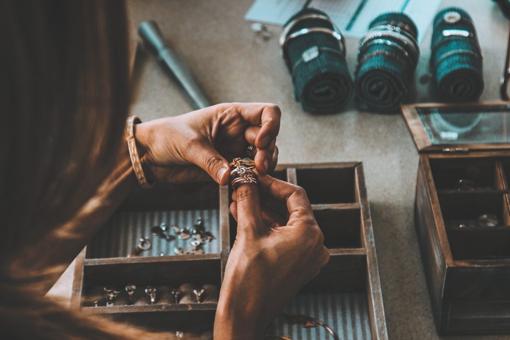 jeweler holding three rings